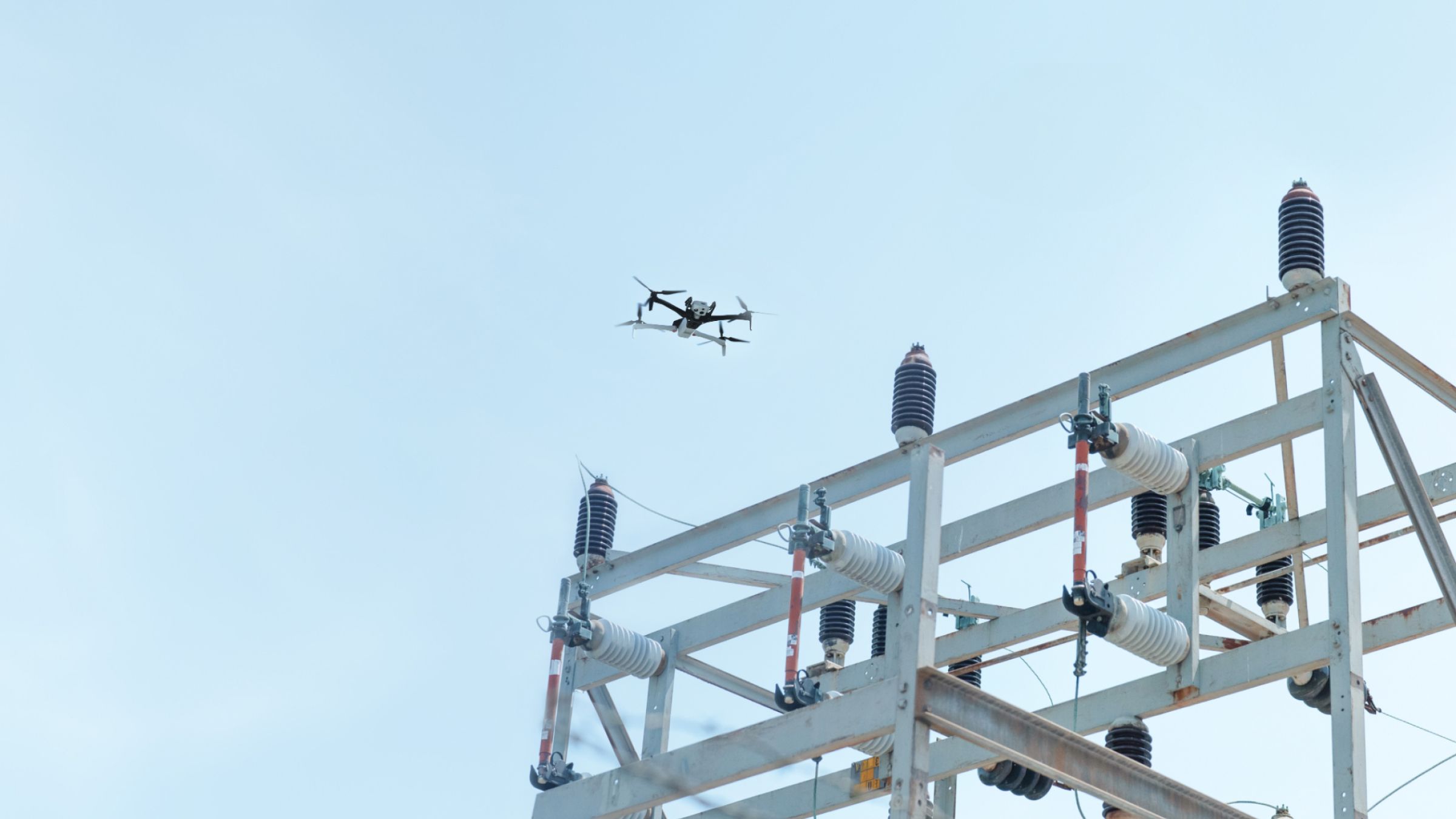 Skydio X10 inspection drone flying above an electrical substation