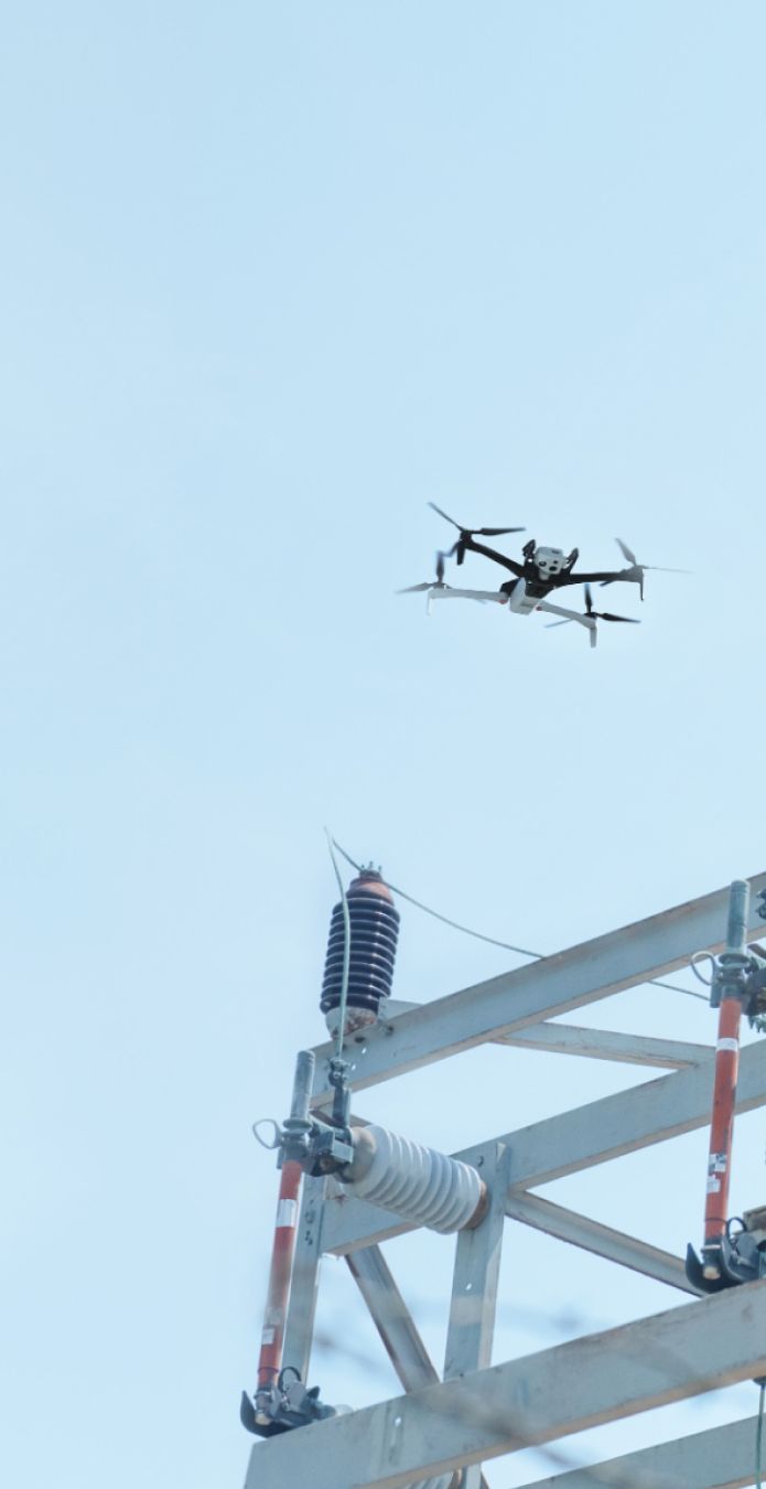 Skydio X10 inspection drone flying above an electrical substation