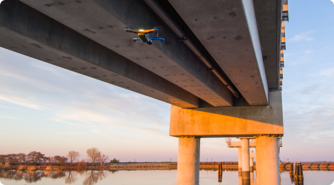 Skydio inspection drone under a cement bridge
