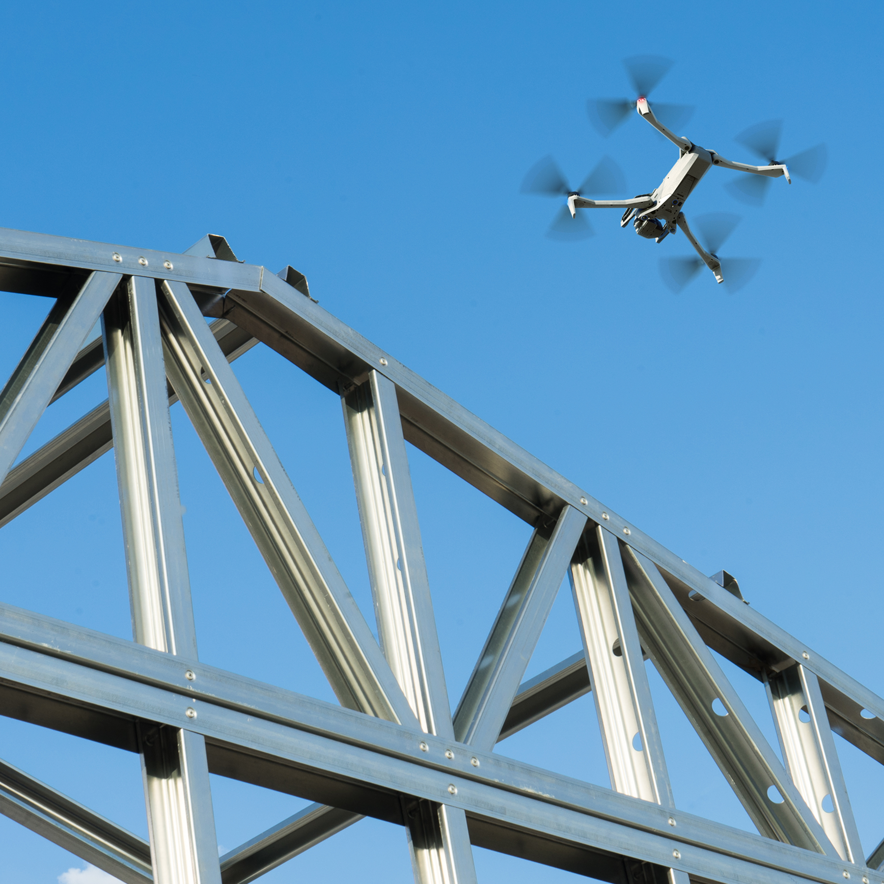 Skydio X10 inspecting metal framing structure at a construction site